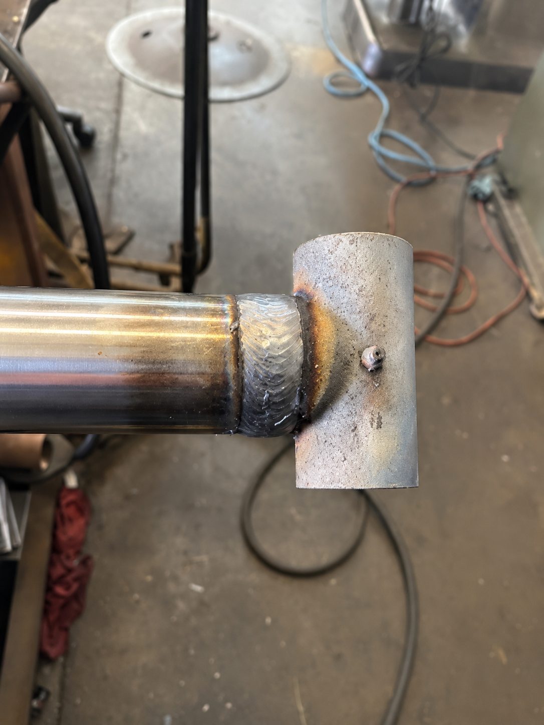 Professional welder mid-arc with bright MIG welding sparks